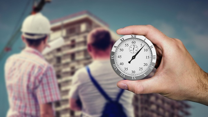 Ansicht einer Baustelle mit Stoppuhr im Vordergrund